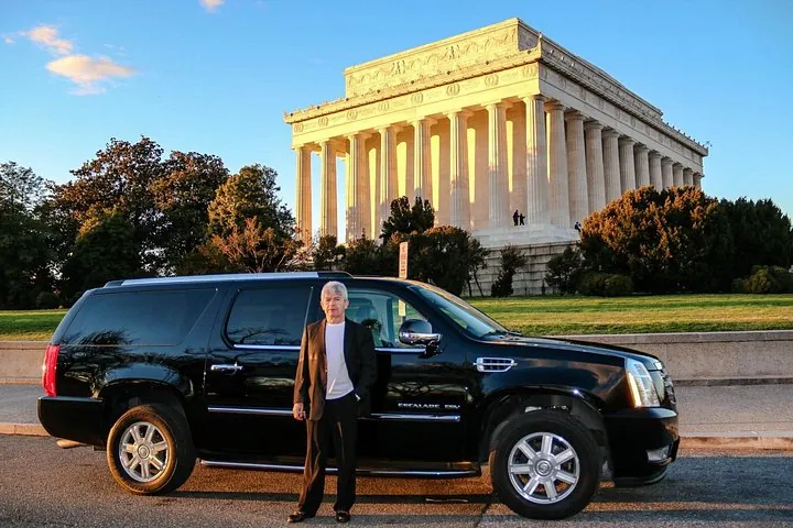 A private tour vehicle and its driver-guide parked below the Lincoln Memorial on a private Washington DC tour for seniors