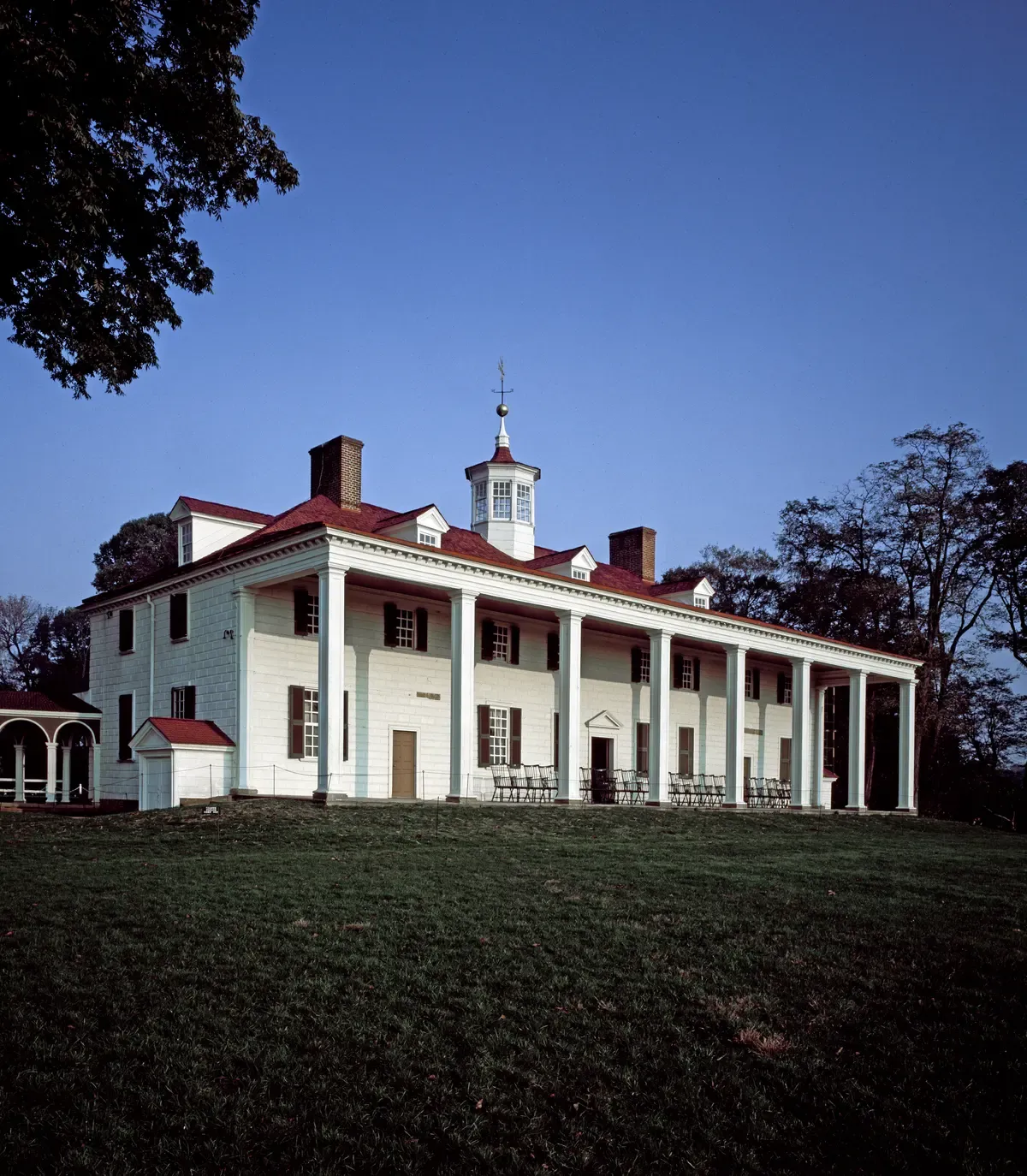 The white columned piazza of George Washington's Mount Vernon mansion above its lawn, the afternoon stop on Washington DC tours for seniors